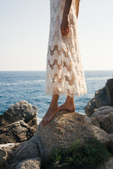 Detail the bottom of the norfolk strapless lace dress in ivory colour by Lilya