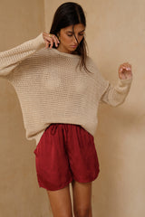 Relaxed satin shorts in Merlot Red by LILYA. 