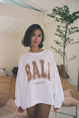 A close up look of the We Like Bali Sunsets on My Mind white sweater for bali souvenirs 