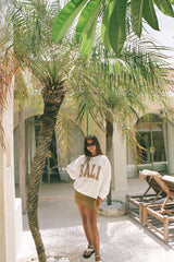 A model wearing We Like Bali Sunsets on My Mind white sweater for bali souvenirs 