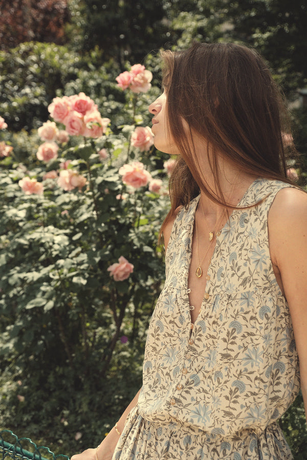 close up of a woman wearing a sleeveless floral dress