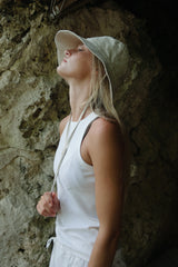 a girl wearing white beach hat