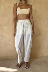 Woman wearing the Coconut Pants in Coconut Ivory with a relaxed straight-leg silhouette and elasticated drawstring waist.