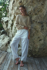 Model wearing the Coconut Pants in Coconut Ivory showing the elasticated waistband, adjustable drawstring and large side pockets.