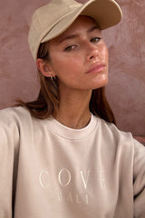 a women wearing cove. bali shirt in sand color