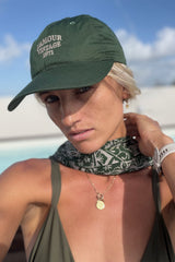a woman wearing a green vintage cap
