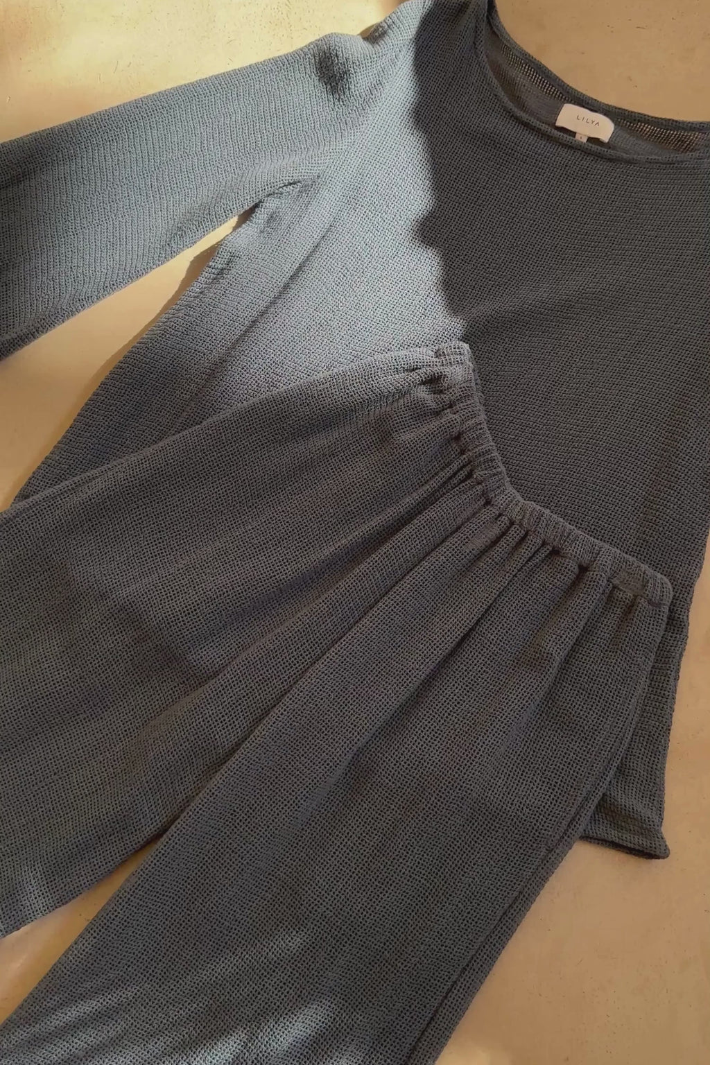 Video showing open weave mesh fabric in storm blue for the LILYA summer set. 