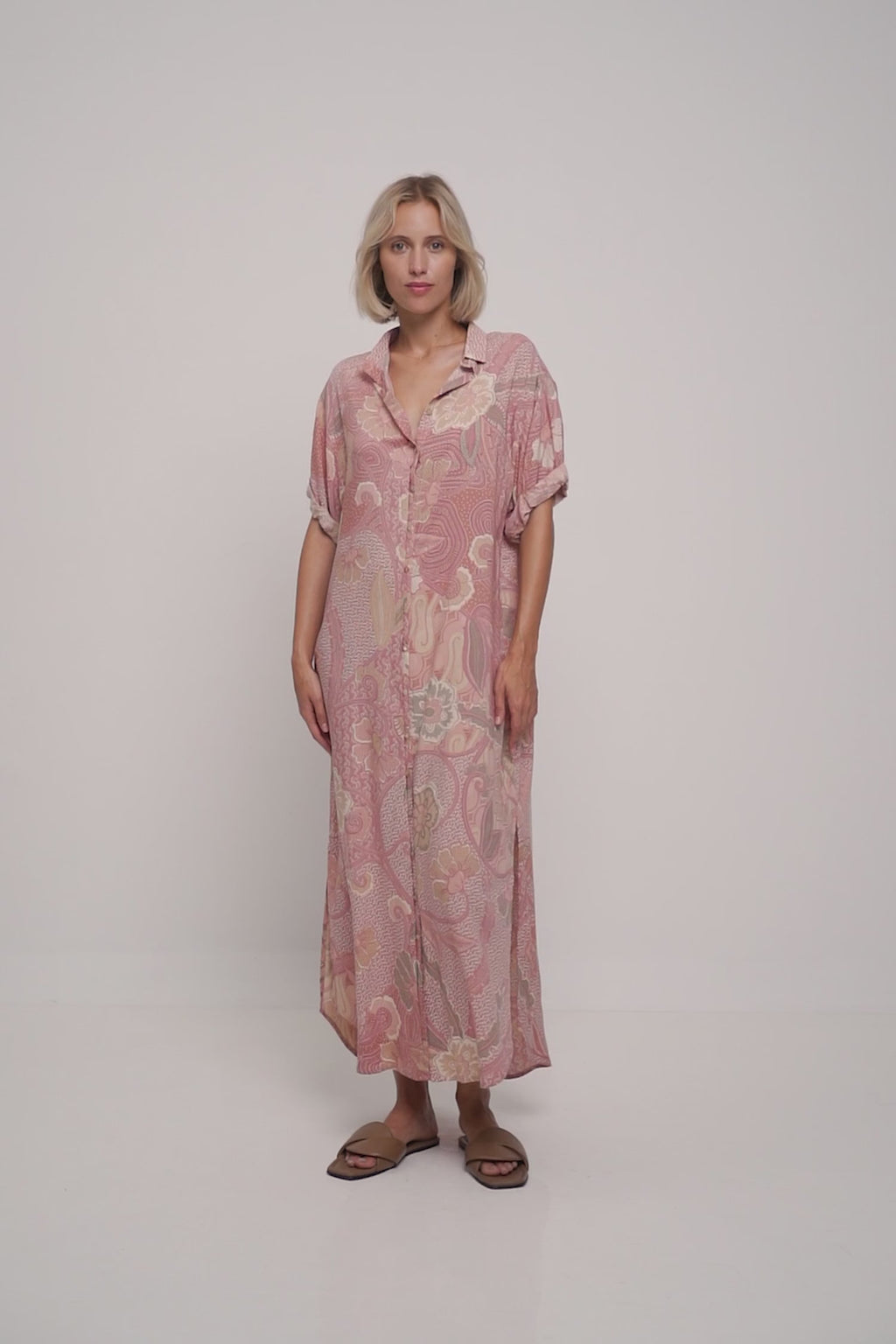 A model wearing a summer pink floral maxi dress by Lilya