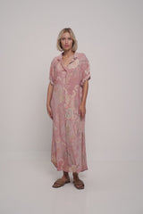 A model wearing a summer pink floral maxi dress by Lilya