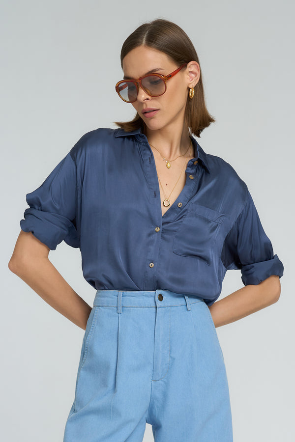 Model wears the LILYA ocean blue relaxed-fit shirt styled with soft chambray pants.