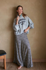 Model wears maxi skirt in floral print with crew neck sweater