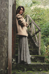 Model wears maxi floral skirt with jacket