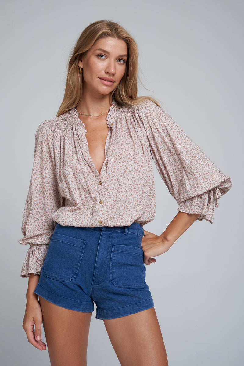 A Model Wearing 70's Style High Rise Denim Blue Shorts