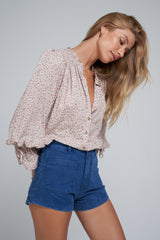 A Woman Wearing High Rise Blue Denim Shorts for Summer