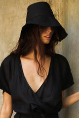 A woman wearing black bucket hat by LILYA