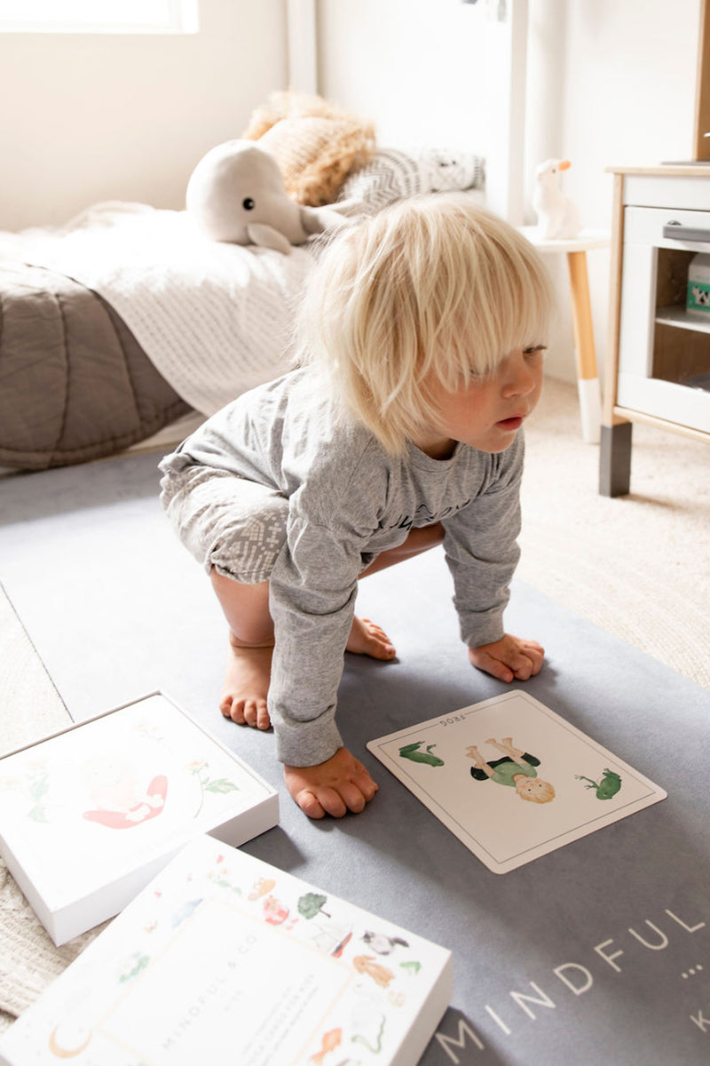A kid playing Yoga Flash Card by Mindful & Co.